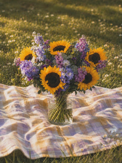 Eleanor summer sunflower bouquet video — hand-tied arrangement of golden sunflowers, blue delphiniums and purple stocks from Guernsey Flowers by Post